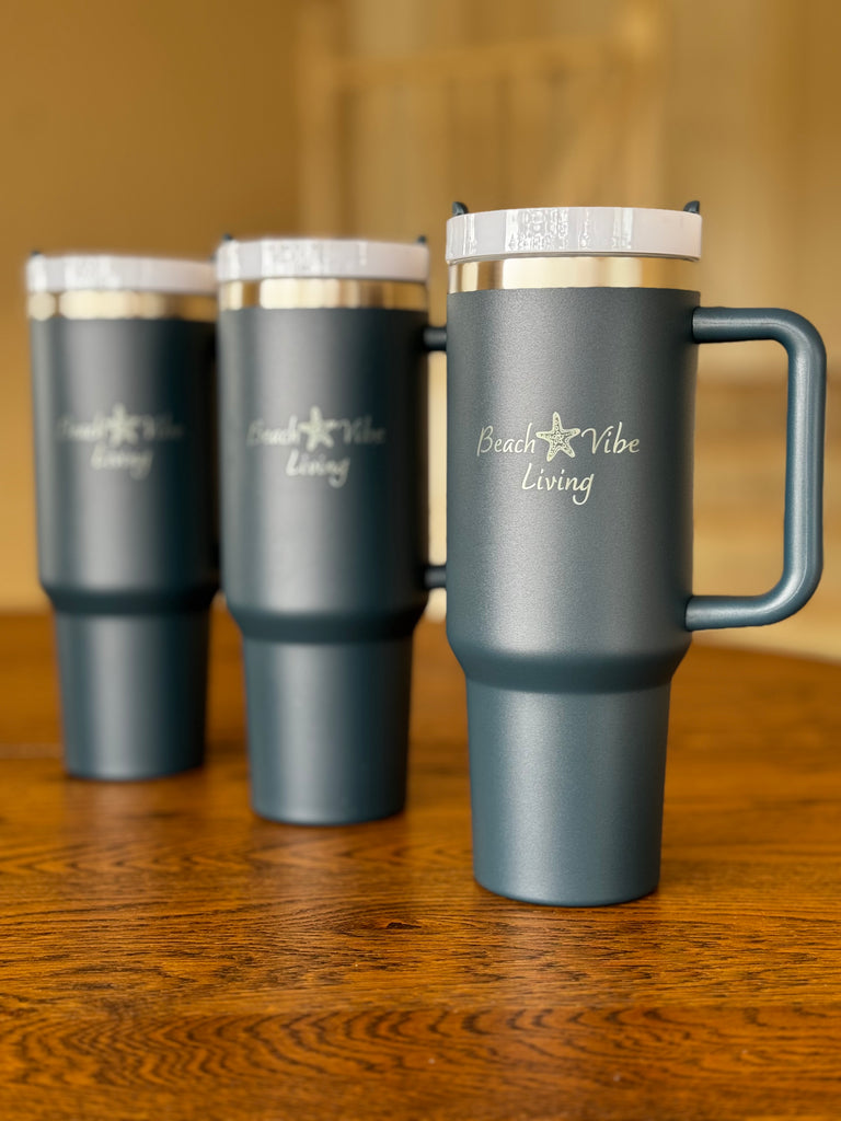 Collection of tumbler cups with Beach Vibe Living logo